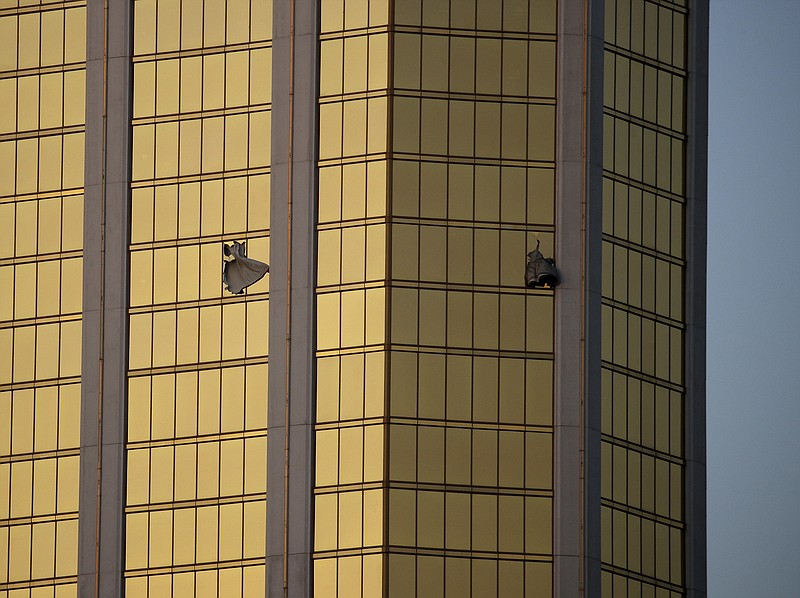 In this Monday, Oct. 2, 2017 file photo, drapes billow out of broken windows at the Mandalay Bay resort and casino on the Las Vegas Strip, following a mass shooting at a music festival in Las Vegas. Police in Las Vegas plan to release witness statements and officer reports of the Oct. 1 gunfire that killed 58 people and injured hundreds in the deadliest mass shooting in modern U.S. history. The scheduled release of documents on Wednesday, May 16, 2018, comes more than seven months after the shooting on the Las Vegas Strip. (AP Photo/John Locher, File)