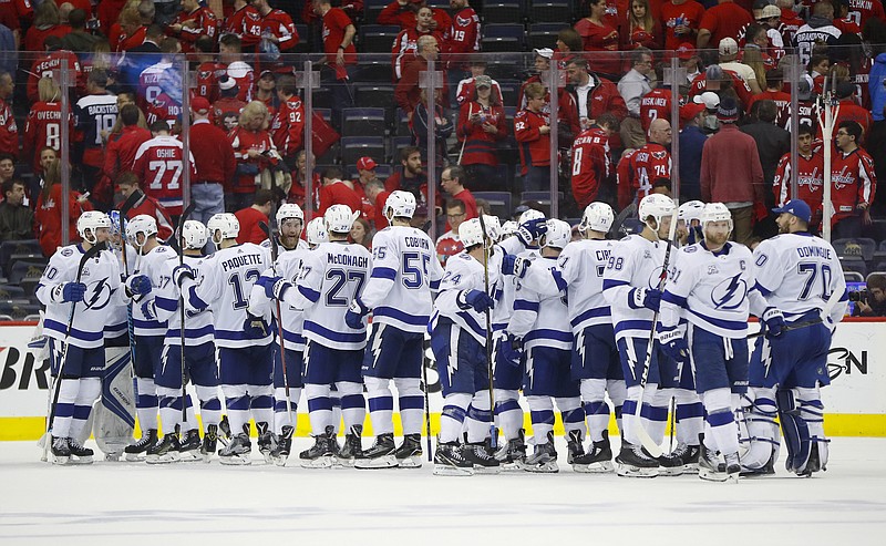 Members of the Tampa Bay Lightning celebrate on the ice at the end of Game 4 of the NHL Eastern Conference finals hockey playoff series against Washington Capitals on Thursday, May 17, 2018, in Washington. Tampa Bay won 4-2. (AP Photo/Pablo Martinez Monsivais)