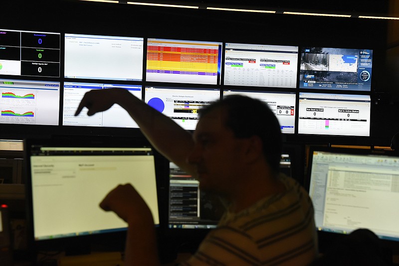 An EPB Fiber Optic controller talks to a co-worker Thursday following an FCC's decision that allows Gigabit Internet service to expand beyond the Chattanooga area. 
