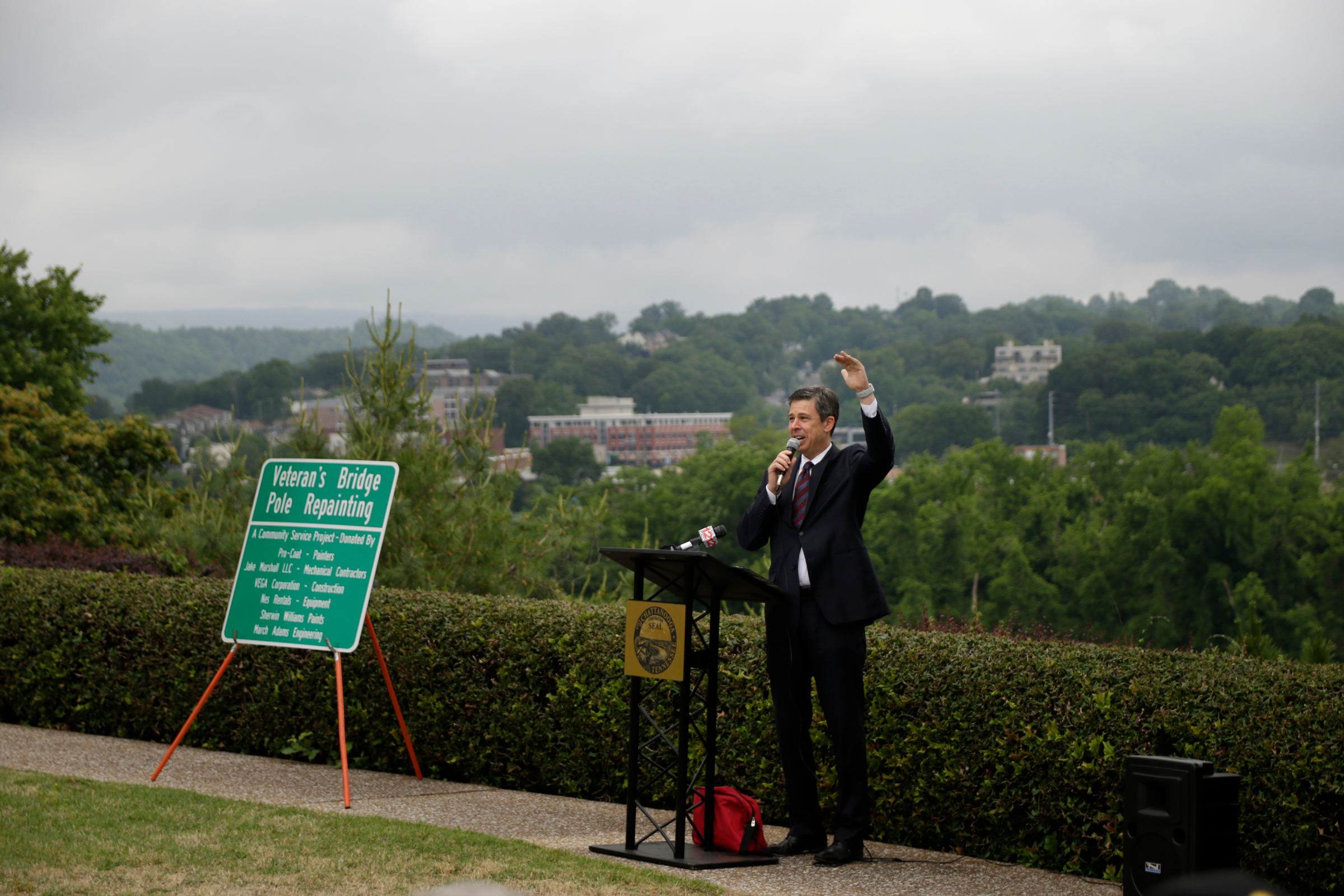 Mayor Andy Berke speaks in the Bluff View Sculpture Garden during the Veterans Bridge Flag Raising Ceremony on Friday, May 18, 2018, in Chattanooga, Tenn. The annual installation of new American flags on the bridge ahead of Armed Forces Day honors the city's veterans.