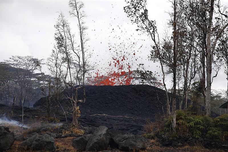 Lava shoots out of a fissure on Pohoiki Rd, Friday, May 18, 2018, near Pahoa, Hawaii. 