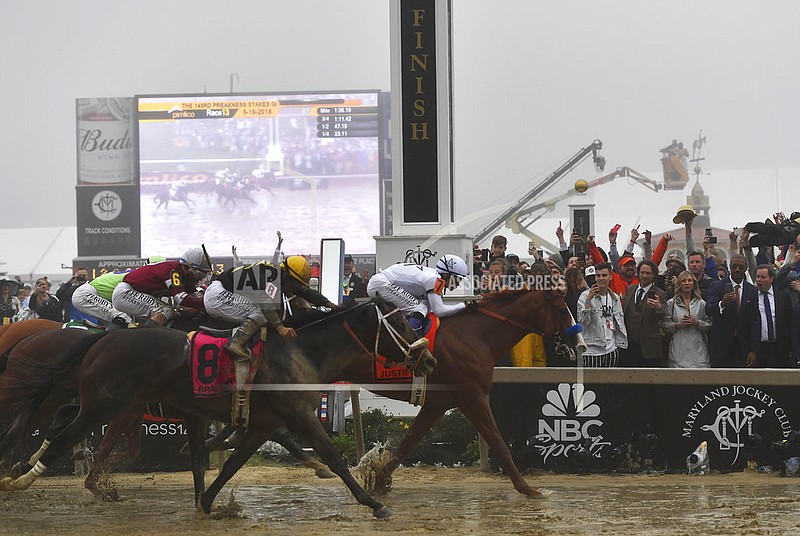 Justify with Mike Smith atop wins the 143rd Preakness Stakes horse race at Pimlico race track, Saturday, May 19, 2018, in Baltimore. 