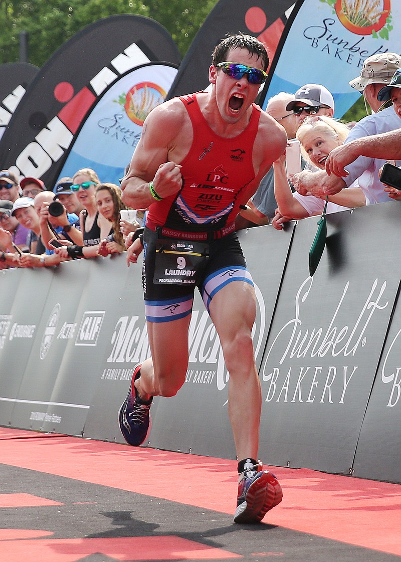 Jackson Laundry celebrates as he crosses the finish line during Ironman 70.3 Chattanooga Sunday, May 20, 2018 in Chattanooga, Tenn. Laundry placed second in the race with a time of 3:47:16.