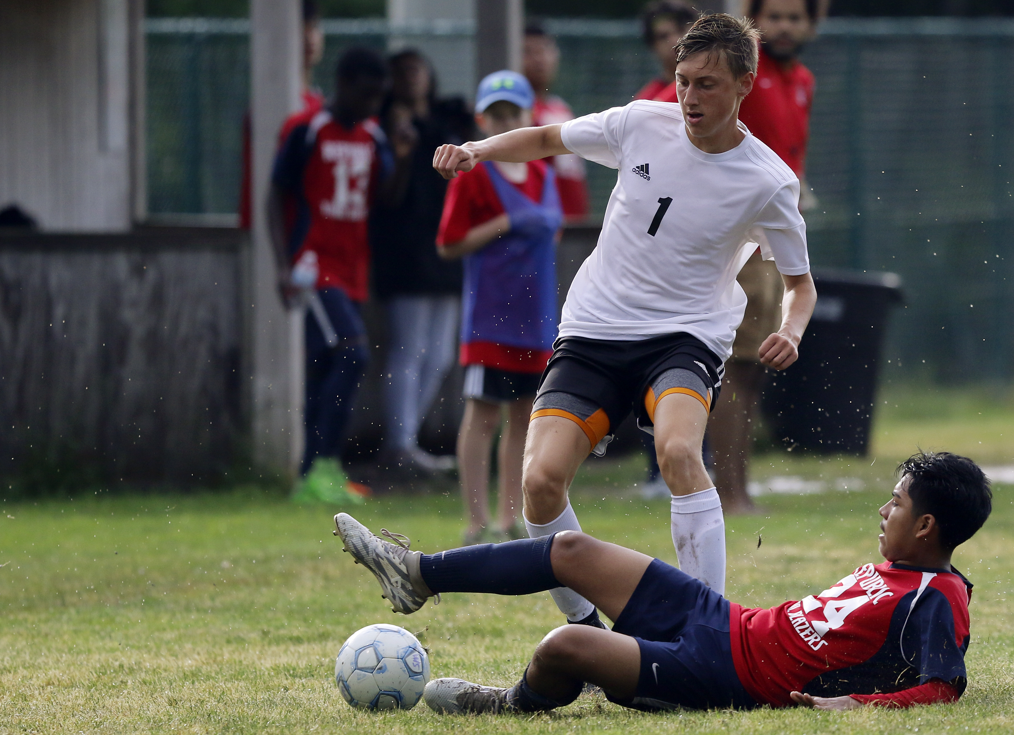RePublic's Jesus Martinez (24) tackles the ball away from Signal Mountain's George Coogan (1) at Signal Mountain Middle/High School on Sunday, May 20, 2018 in Signal Mountain, Tenn.