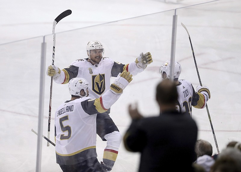 Vegas Golden Knights' Deryk Engelland (5), Ryan Carpenter (40) and Alex Tuch (89) celebrate after Tuck scored during first period NHL Western Conference Finals game 5 hockey action against the Winnipeg Jets, in Winnipeg, Sunday, May 20, 2018. (Trevor Hagan/The Canadian Press via AP)