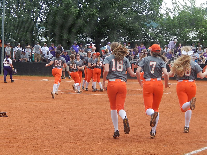 Meigs County's Lady Tigers rush to the pitcher's circle to celebrate their advancing to the TSSAA state softball tournament for a fourth consecutive year after defeating Sequatchie County 7-0 on Sunday. Meigs won the last two Class A titles but this year they're competing in Class AA.