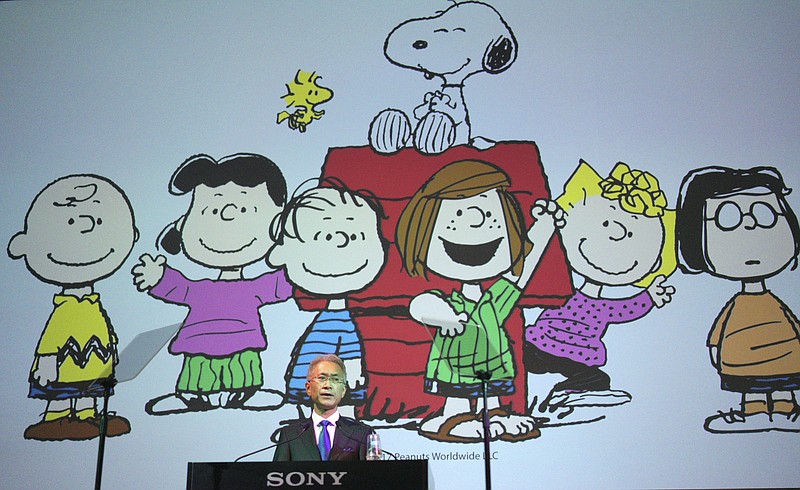 
              Sony Corp. President Kenichiro Yoshida speaks as characters from Peanuts are shown at a press conference at the company's headquarters Tuesday, May 22, 2018, in Tokyo. Electronics and entertainment company Sony Corp. is investing 1 trillion yen ($9 billion) mostly in image sensors over the next three years. Sony Corp. said last week that it is buying a stake in Peanuts Holdings, the company behind Snoopy and Charlie Brown. (AP Photo/Eugene Hoshiko)
            