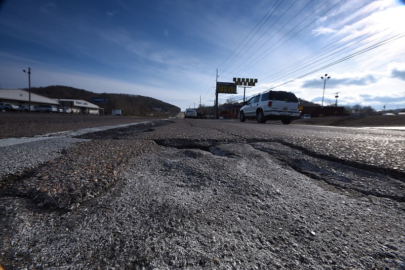 Damaged pavement and potholes create obstacles for southbound motorists in the left lane on Dayton Pike in Chattanooga at state Highway 153. Across the state line, Walker County is working to address its own potholes.