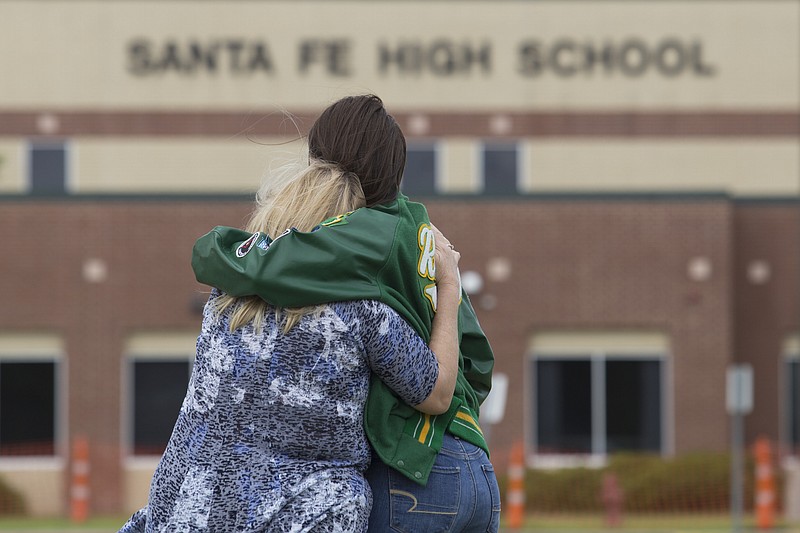Senior Amy Roden, who knew one of the victims, and her grandmother Gail, embrace outside Santa Fe High School in Santa Fe, Texas, on Sunday. A gunman killed 10 people and wounded 13 others at the high school on Friday. (Michael Stravato/The New York Times)