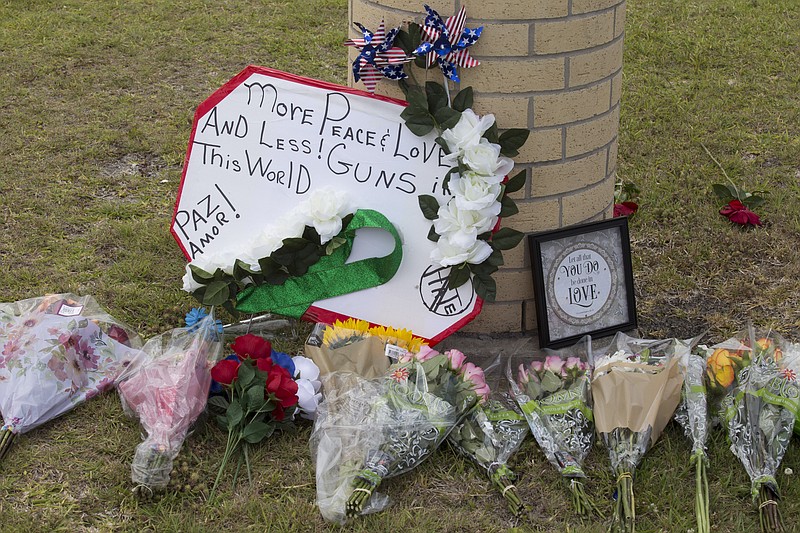 A makeshift memorial for shooting victims outside Santa Fe High School in Santa Fe, Texas. A 17-year-old student killed 10 people and wounded 13 others at the high school on Friday. (Michael Stravato/The New York Times)