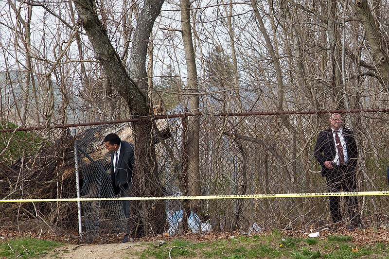 Detectives search the area where the bodies of four young Latino men were discovered in Central Islip, N.Y., in April 2017. Authorities arrested more than 15 members of the MS-13 gang in the homicides. (Uli Seit/The New York Times)