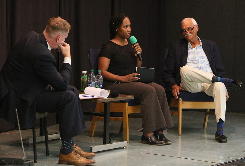 Scott Shaw, the moderator, listens as Miracle Hurley and incumbent Hamilton County School Board member Joe Smith respond to questions during the District 3 school board debate at Hixson High School Monday, May 21, 2018 in Hixson, Tenn. A set of questions had already been sent to the candidates to prepare for, and additional questions were asked by audience members during the debate.