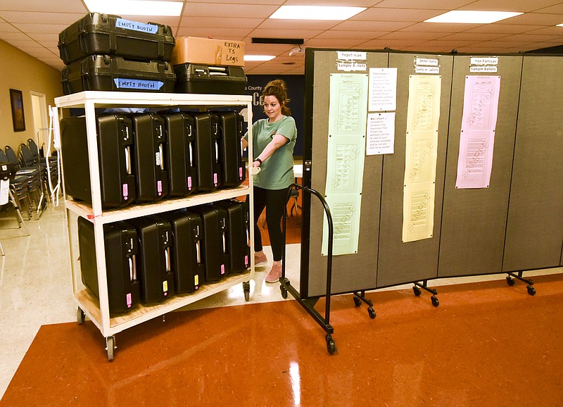 Catoosa County Election technician Rebekah Crawford moves a cart of voting machines to be ready for transport to various locations around Catoosa County.