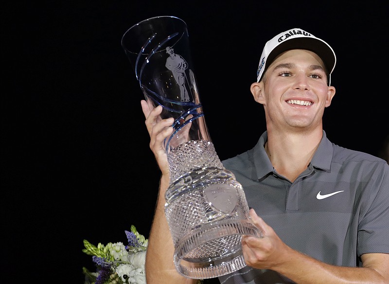 Aaron Wise holds up the trophy after winning the AT&T Byron Nelson golf tournament in Dallas, Sunday, May 20, 2018. (AP Photo/Eric Gay)