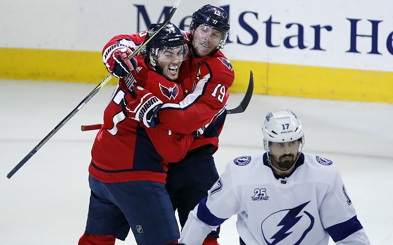 Washington Capitals right wing T.J. Oshie, left, and center Nicklas Backstrom, from Sweden, celebrate a goal by Oshie with Tampa Bay Lightning left wing Alex Killorn (17) nearby during the second period of Game 6 of the NHL Eastern Conference finals hockey playoff series, Monday, May 21, 2018, in Washington. (AP Photo/Alex Brandon)
