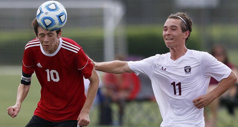 Signal Mountain's Max Gray (10) heads the ball while being defended by Alcoa's Logan Hickey (11) during their Division I Class A quarterfinal match during Spring Fling XXV at Richard Siegel Soccer Park on Tuesday, May 22, 2018 in Murfreesboro, Tenn.