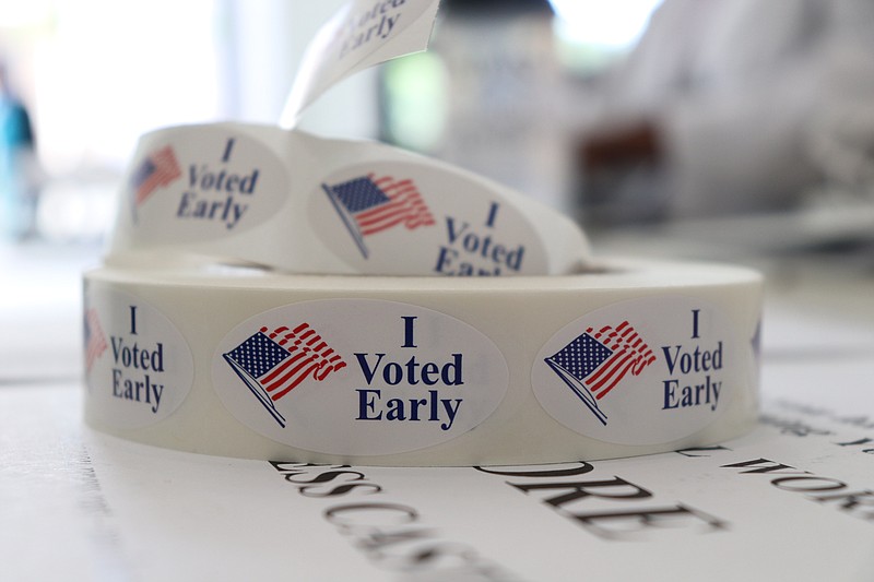 In this May 21, 2018, photo, a roll of stickers awaiting distribution to early voters sits on a table at the check-in station at the Pulaski County Courthouse Annex in Little Rock, Ark. Voters in four states are casting ballots Tuesday as the 2018 midterm elections take shape. Primaries are set in Arkansas, Georgia and Kentucky while voters in Texas settle several primary runoffs from their first round of voting in March. (AP Photo/Kelly P. Kissel)