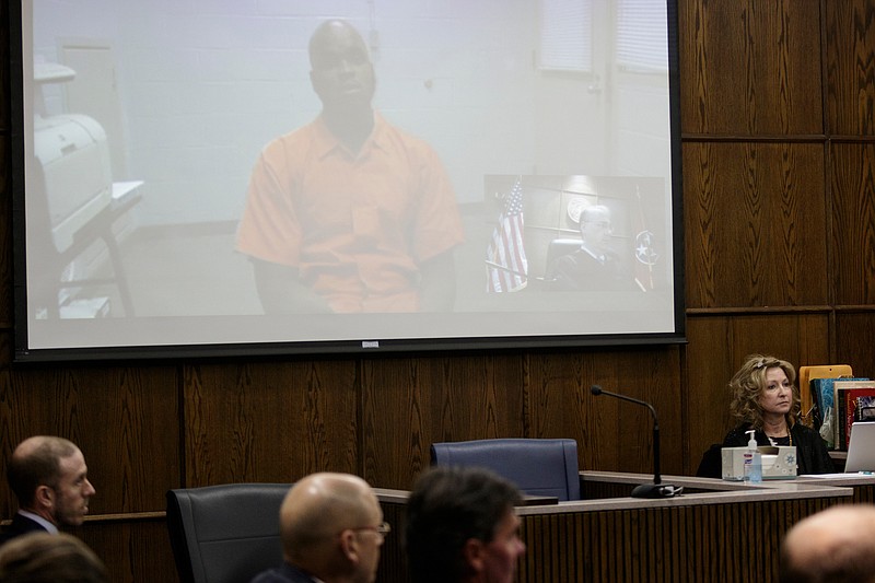 Cortez Sims is arraigned via remote video in Judge Tom Greenholtz's courtroom in the Chattanooga-Hamilton County Courts Building on Friday, April 27, 2018, in Chattanooga, Tenn. Forty-five of the alleged Athens Park Blood gang members indicted last month on RICO charges were arraigned Friday.