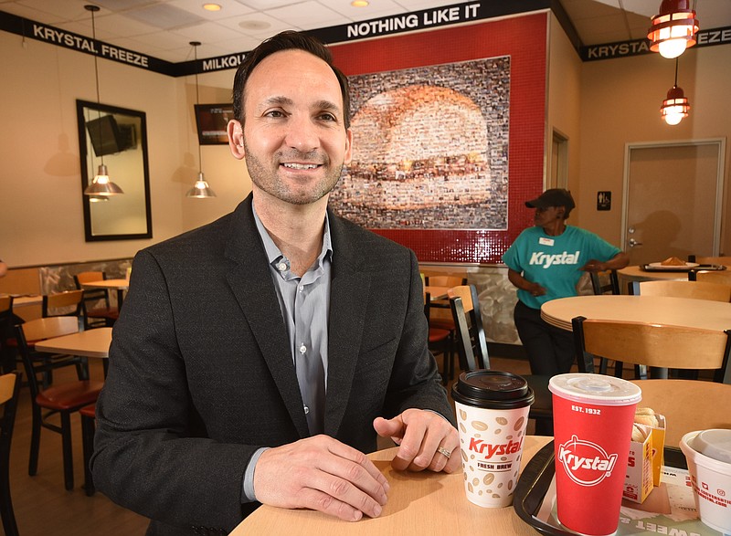Paul Macaluso, CEO of Krystal restaurants, talks about trying to boost profits after taking the helm of the Atlanta based company during an interview inside the Broad Street location in Chattanooga Monday morning. Longtime employee Pat "Miss Pat" Lawson is seen in the dining area, at right.