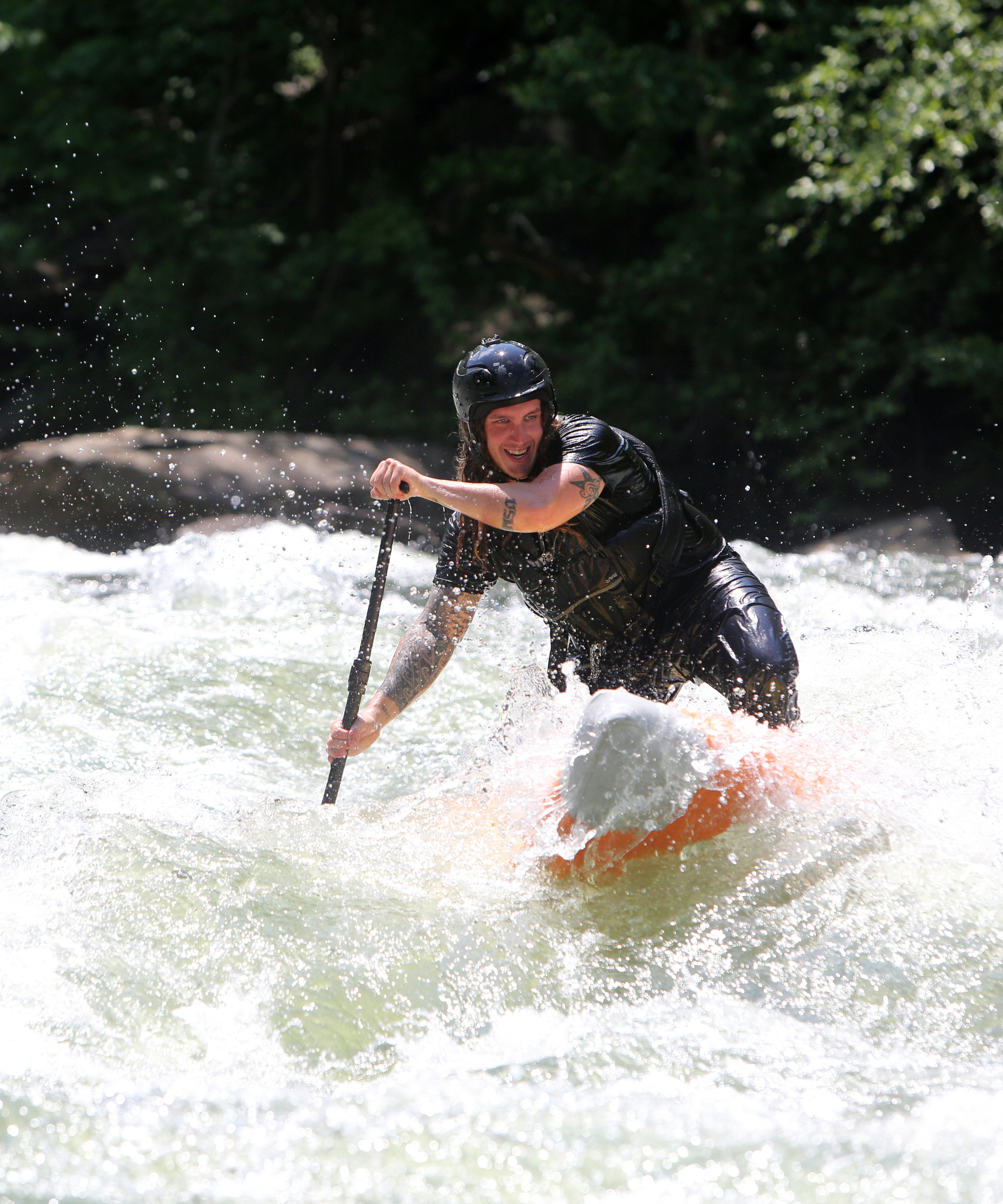Alex Storgion makes his way through rapids on his stand-up paddleboard on the Ocoee River.