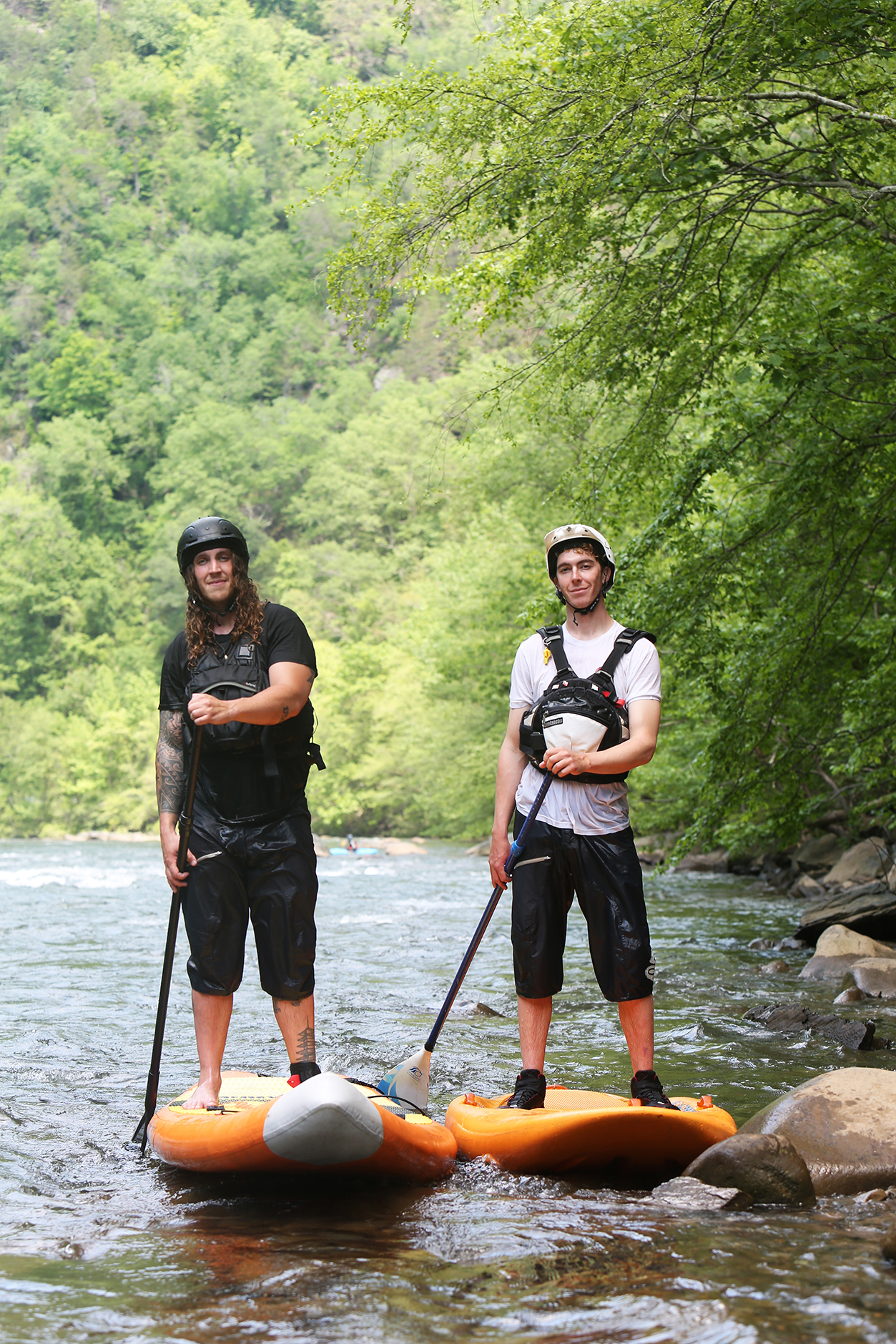 Alex Storgion, 26, and Chris Storgion, 24, pose for a photo with their paddle boards on the Ocoee River in Benton, Tenn., Monday, May 14, 2018.