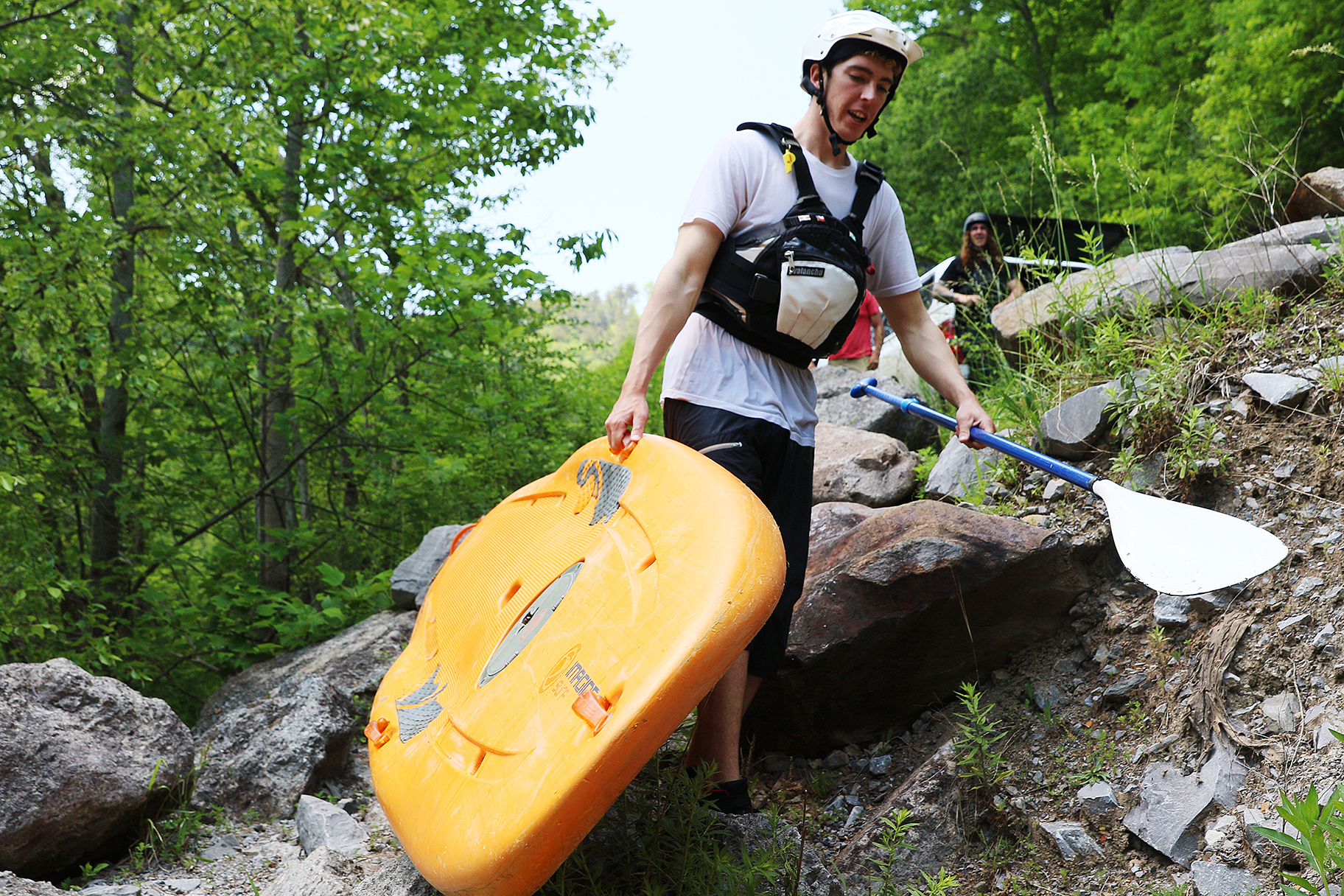Chris Storgion, 24, carries his standup paddle board down to the Ocoee River in Benton, Tenn., Monday, May 14, 2018.