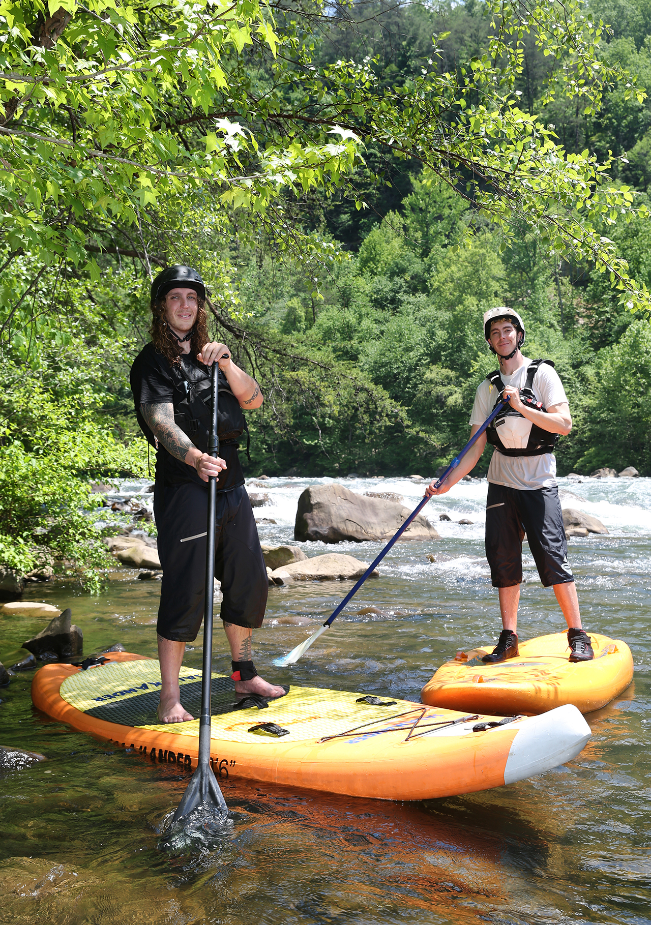 Alex Storgion, 26, and Chris Storgion, 24, pose for a photo with their paddle boards on the Ocoee River in Benton, Tenn., Monday, May 14, 2018.
