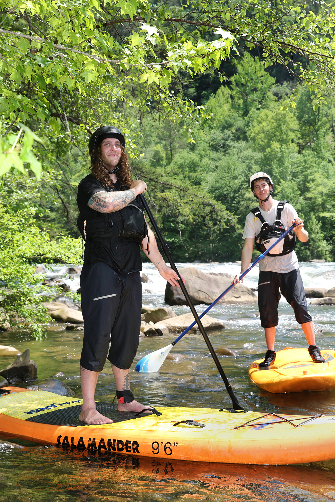 Alex Storgion, 26, and Chris Storgion, 24, pose for a photo with their paddle boards on the Ocoee River in Benton, Tenn., Monday, May 14, 2018.