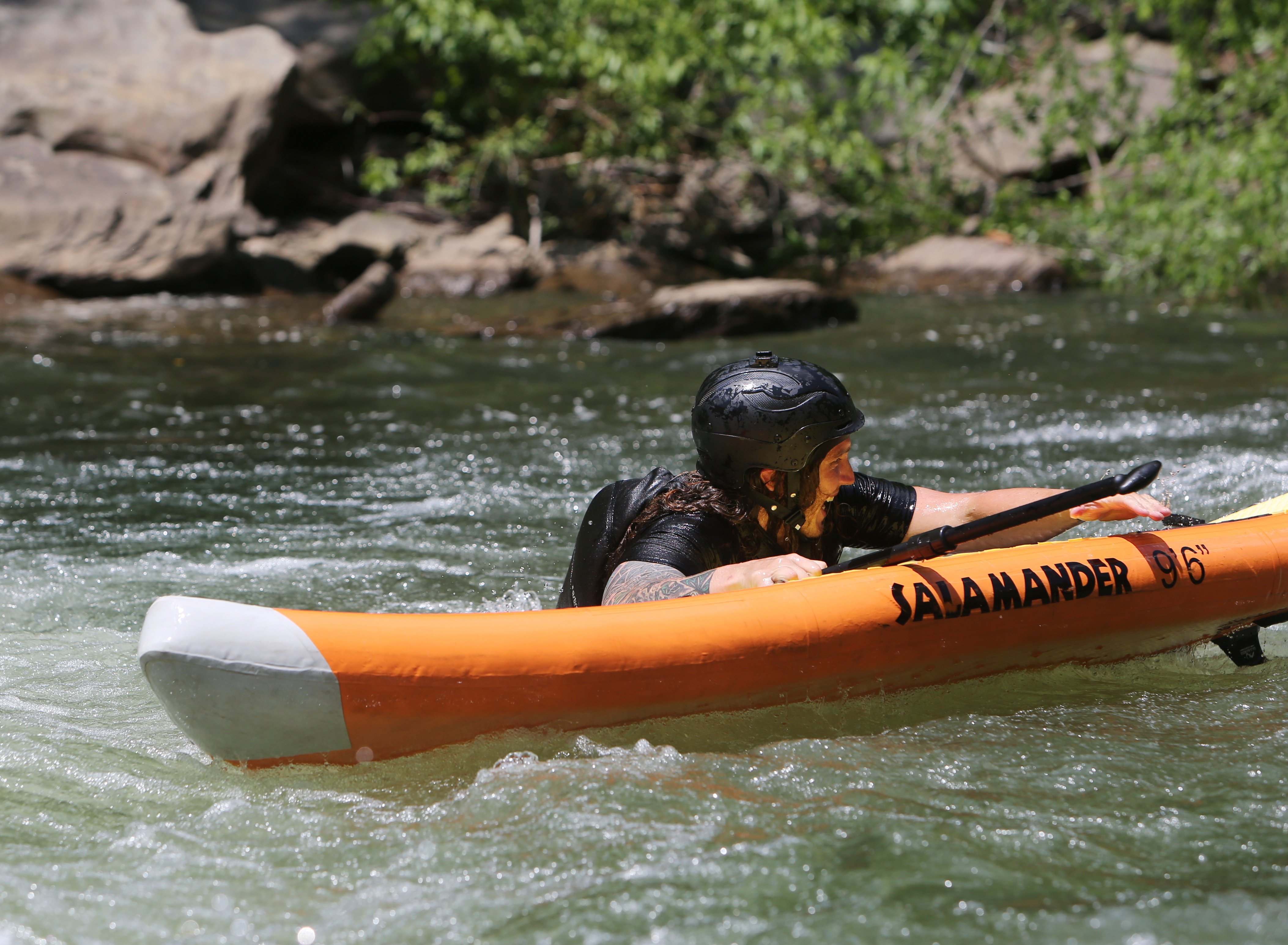 Alex Storgion, 26, laughs after falling off of his standup paddle board while going through rapids on the Ocoee River in Benton, Tenn., Monday, May 14, 2018.
