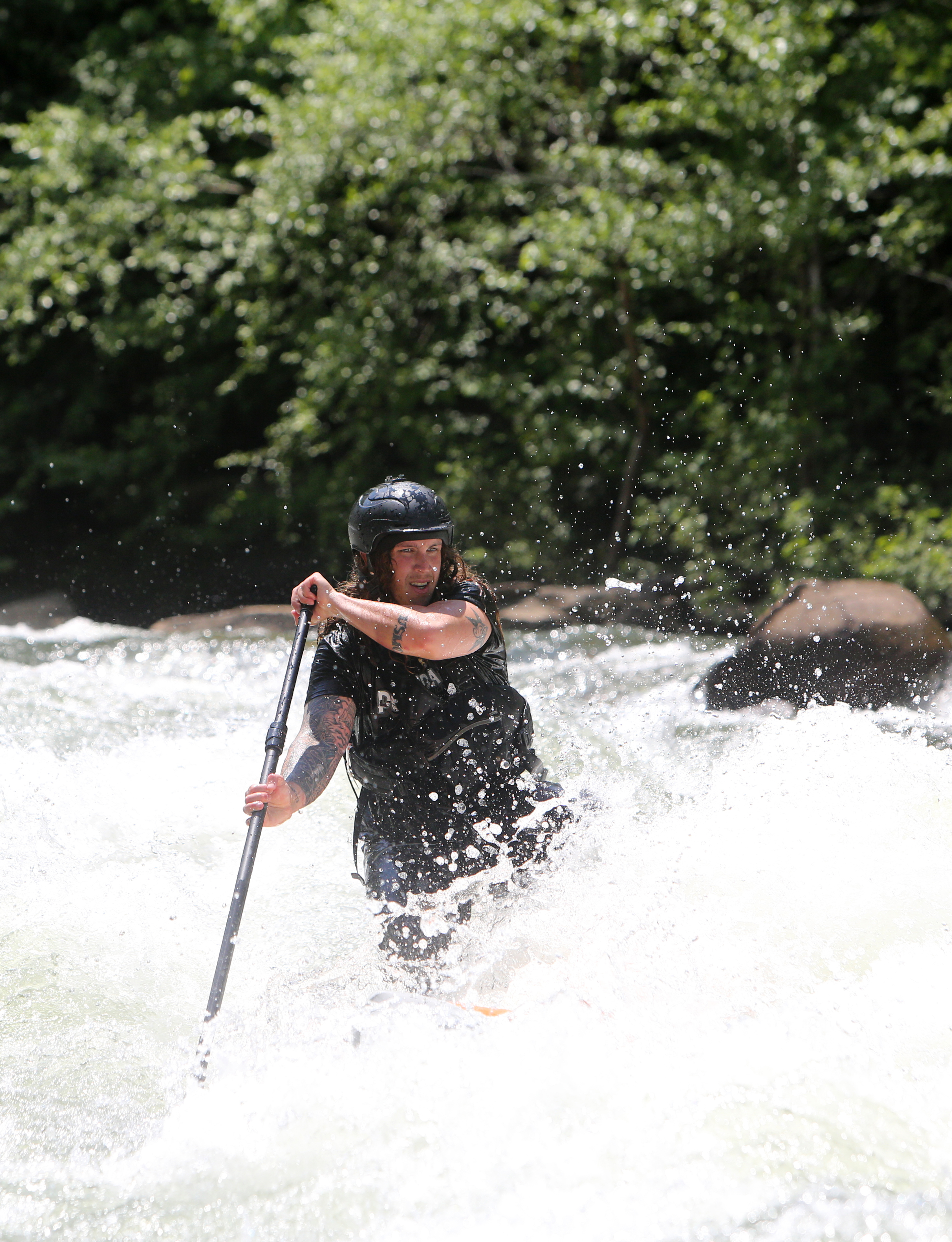 Alex Storgion, 26, makes his way through rapids on his standup paddle board on the Ocoee River in Benton, Tenn., Monday, May 14, 2018.