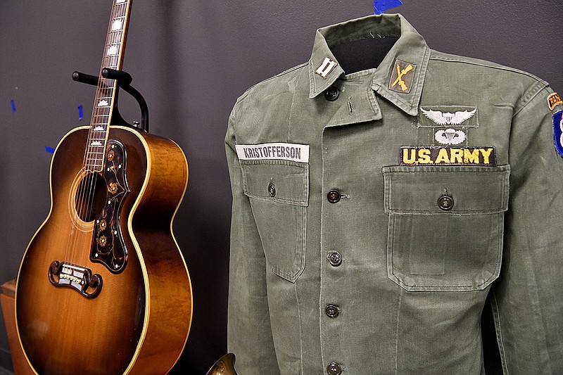 A guitar owned by Cowboy Jack Clement sits next to Kris Kristofferson's Army uniform. When Kristofferson came to Nashville after leaving the military, Clement was one of the first people he met, and the two became friends. (Larry McCormack / The Tennessean)