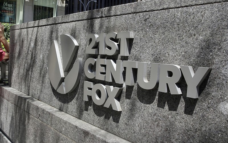 FILE - This Aug. 1, 2017, file photo shows the Twenty-First Century Fox sign outside of the News Corporation headquarters building in New York. Comcast says it’s considering making an offer to buy Twenty-First Century Fox, which would put it in a head-to-head bidding fight with Disney. (AP Photo/Richard Drew, File)