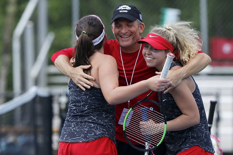 Signal Mountain assistant coach Gordon Williams, center, hugs Grace Williams, left, and Sarah Kate Bailey in celebration after the Lady Eagles won the TSSAA Division I Small Class state title Wednesday at the Adams Tennis Complex in Murfreesboro. It's the program's first state title.