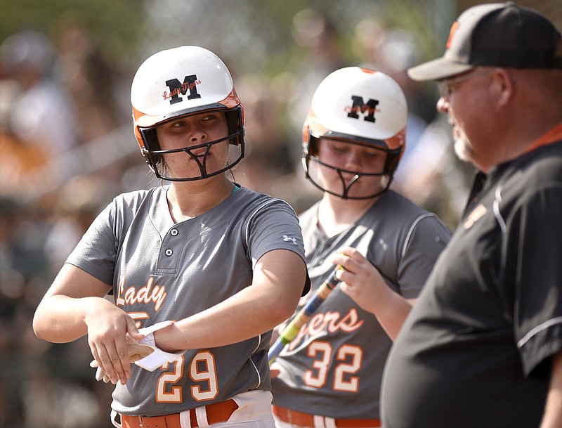 Meigs County head coach Jeff Davis instructs senior Lindsey Ward (29).  The Meigs County Lady Tigers defeated the Kingston Lady Yellow Jackets 9 to 1 in a winners's bracket game of the TSSAA Division 1 Class AA state softball tournament May 23, 2018