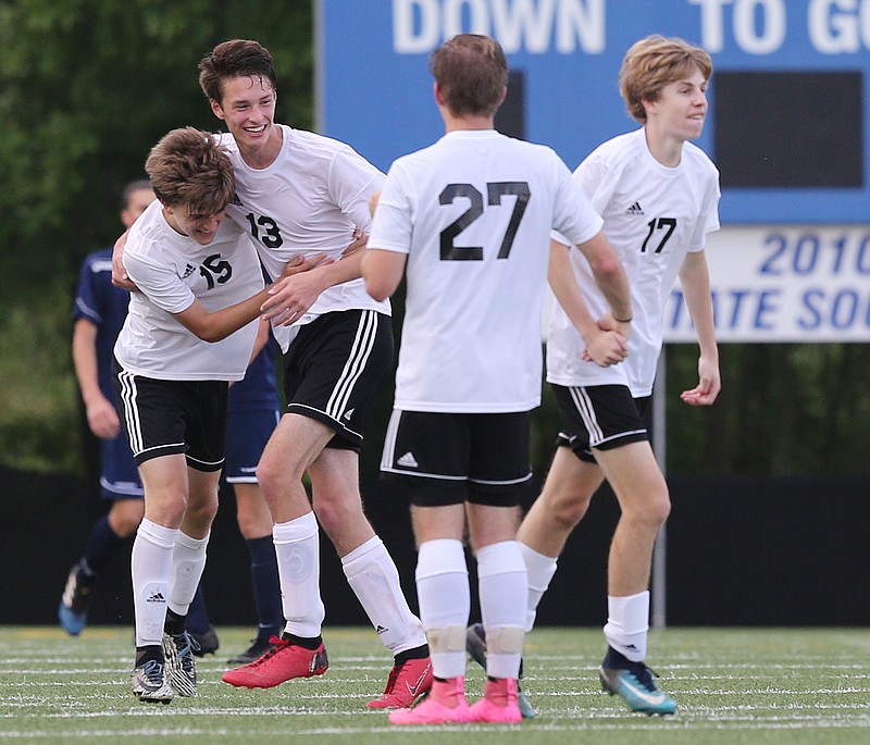 Max Burk, left, celebrates a Signal Mountain goal with teammates Leon Menge (13), Jonathan Miller (27) and Jack Poss (17) during a Region 3-A tournament match against Arts & Sciences last week. Signal beat Franklin Grace 1-0 in the state semifinals Wednesday and will play for the Class A title Friday.