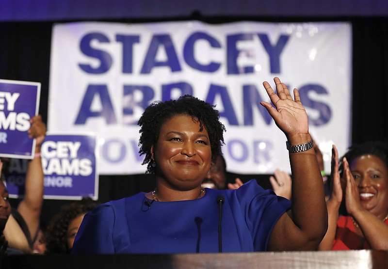 Democratic candidate for Georgia Governor Stacey Abrams waves to supporters after speaking at an election-night watch party Tuesday, May 22, 2018, in Atlanta. (AP Photo/John Bazemore)