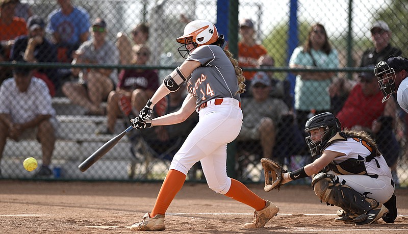 Meigs County's Ashley Rogers (14) makes contact.  The Meigs County Lady Tigers defeated the Kingston Lady Yellow Jackets 9 to 1 in a winners's bracket game of the TSSAA Division 1 Class AA state softball tournament May 23, 2018