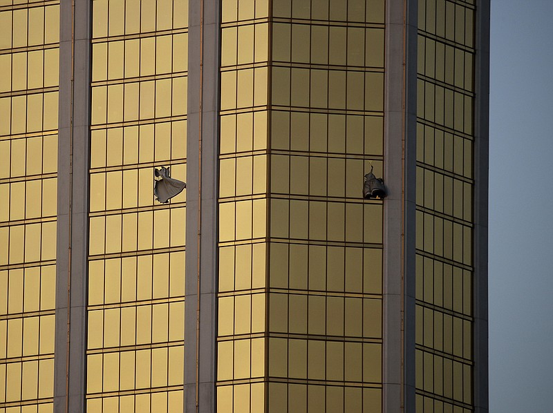 
              FILE - In this Monday, Oct. 2, 2017 file photo, drapes billow out of broken windows at the Mandalay Bay resort and casino on the Las Vegas Strip, following a mass shooting at a music festival in Las Vegas. Police in Las Vegas plan to release witness statements and officer reports of the Oct. 1 gunfire that killed 58 people and injured hundreds in the deadliest mass shooting in modern U.S. history. The scheduled release of documents on Wednesday, May 16, 2018, comes more than seven months after the shooting on the Las Vegas Strip. (AP Photo/John Locher, File)
            
