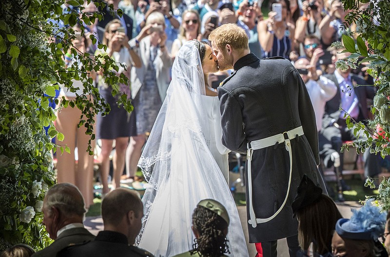 Prince Harry and Meghan Markle kiss on the steps of St George's Chapel at Windsor Castle following their wedding in Windsor Castle in Windsor, near London, England, on May 19, 2018. (Danny Lawson/pool photo via AP)