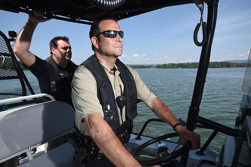 Hamilton County Marine Patrol Deputy Sam Roistacher, right, and J. Matt Lea, Hamilton County Sheriff's Office spokesman, approach a boat for a safety check on Lake Chickamauga near Chester Frost Park.