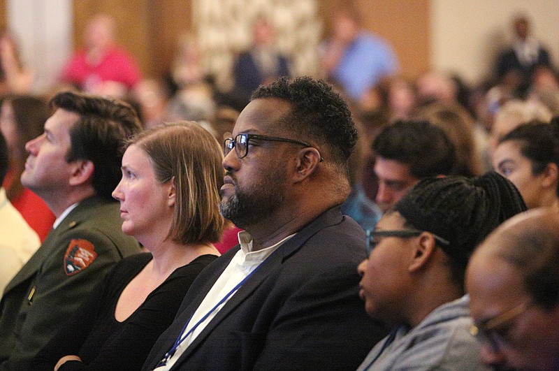 James McKissic, center, director of Multicultural Affairs for the city of Chattanooga, listens to Mayor Andy Berke's state of the city speech in April.