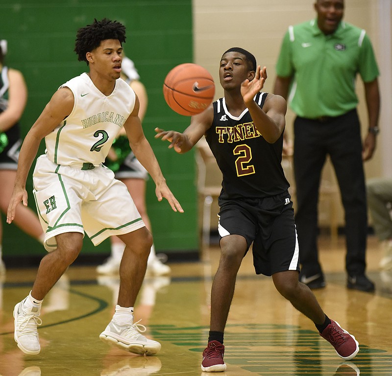 Tyner's Javon Craddock passes past East Hamilton's Cameron Montgomery, left, in a high school basketball game this past January. Craddock collapsed and died after playing a pickup game last week.