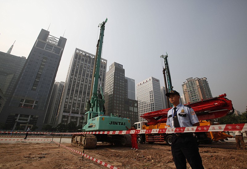 
              FILE - In this Oct. 26, 2009 file photo, security workers guard at construction site of the U.S. Consulate compound in Guangzhou in southern China's Guangdong province. The State Department said an email notice Wednesday, May 23, 2018, that a U.S. government employee in southern China reported abnormal sensations of sound and pressure, recalling similar experiences among American diplomats in Cuba who later fell ill. (Chinatopix via AP, File)
            