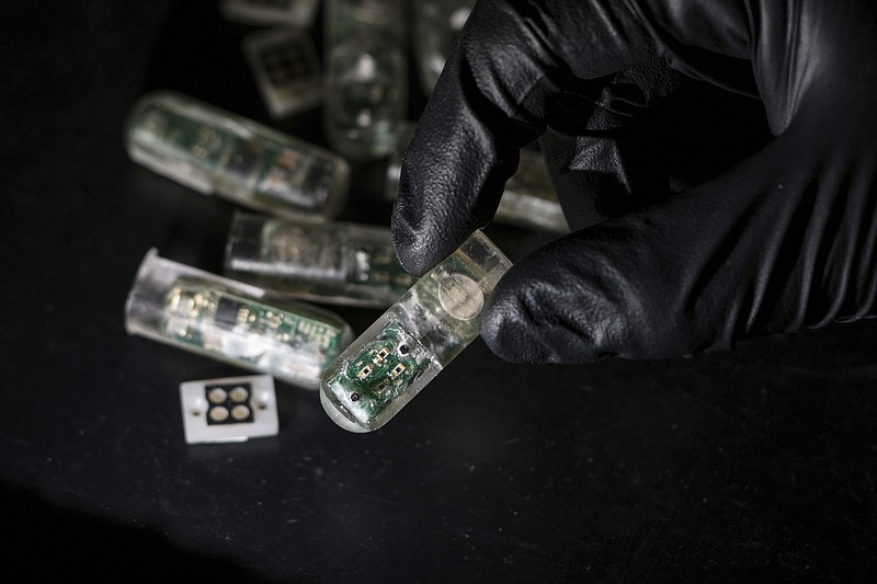 This undated photo provided by the Massachusetts Institute of Technology School of Engineering in May 2018 shows a capsule packed with electronics and genetically engineered living cells in Cambridge, Mass.