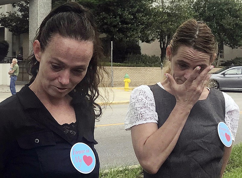Tina Millican, left, and Judy Bradley, both sisters of murder victim Lisa Ann Millican, stand outside Alabama's parole board after members refused to release convicted killer Judith Ann Neelley on Wednesday, May 23, 2018. Relatives opposed Neelley's release and said they were thankful she is not being paroled. (AP Photo/Kim Chandler)