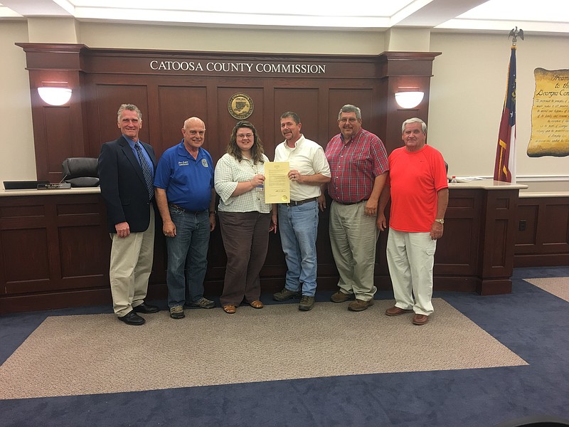 Joy Dodd, center, stands among Catoosa County commissioners after they honored National Foster Care Month during their May 15 meeting. (Contributed photo by Melissa Hannah)
