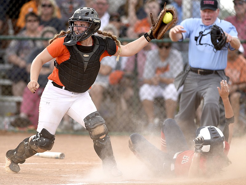 Meigs County catcher Aubrey Reed was unable to get this White House Heritage runner out in a 3-1 loss in the first game of the TSSAA Class AA state softball final. However, the Toledo signee hit a key two-run homer early as the Lady Tigers won the next game and the championship.