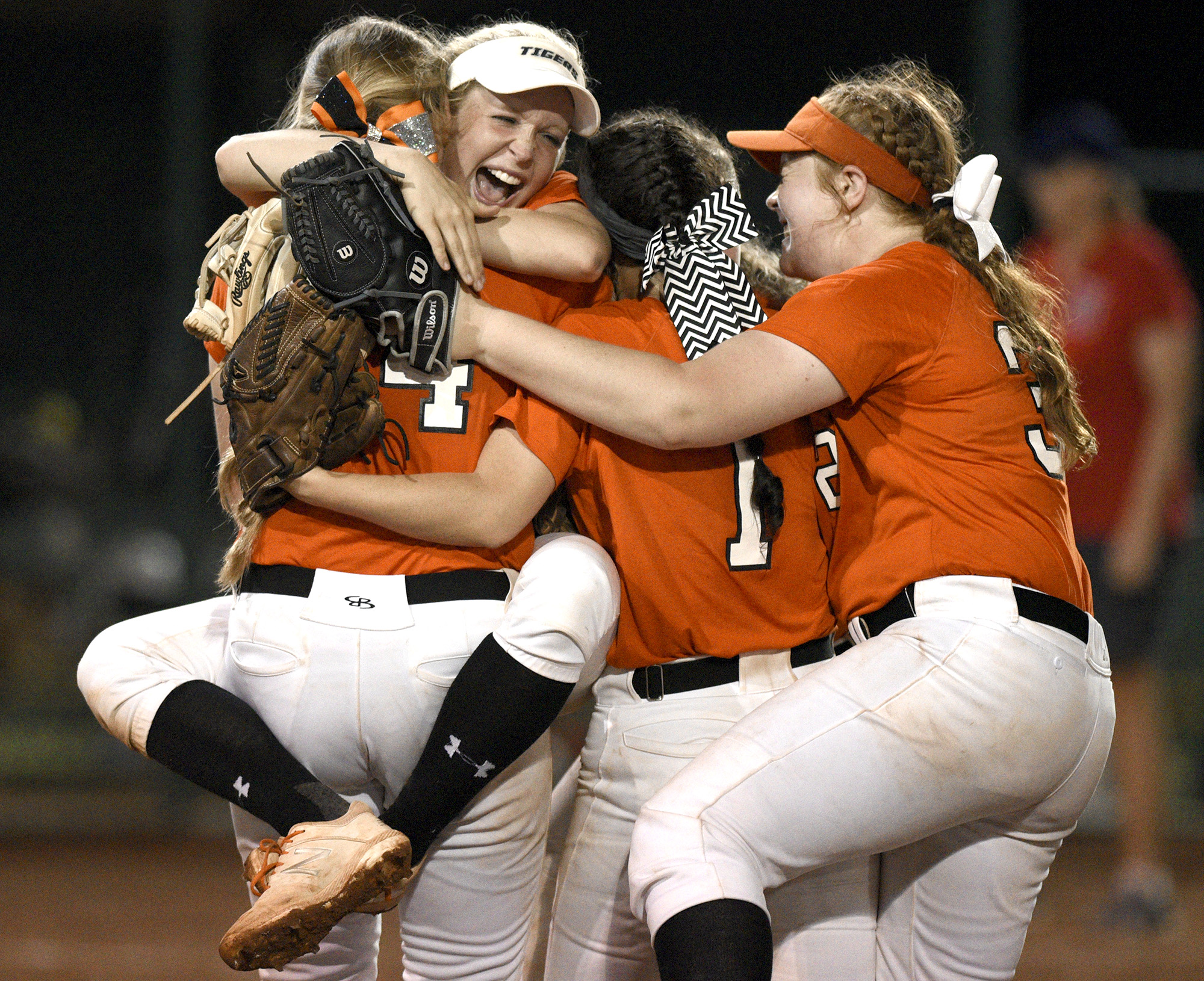 Meigs County softball players embrace after the final out of the program's third state championship in three years in Murfreesboro.