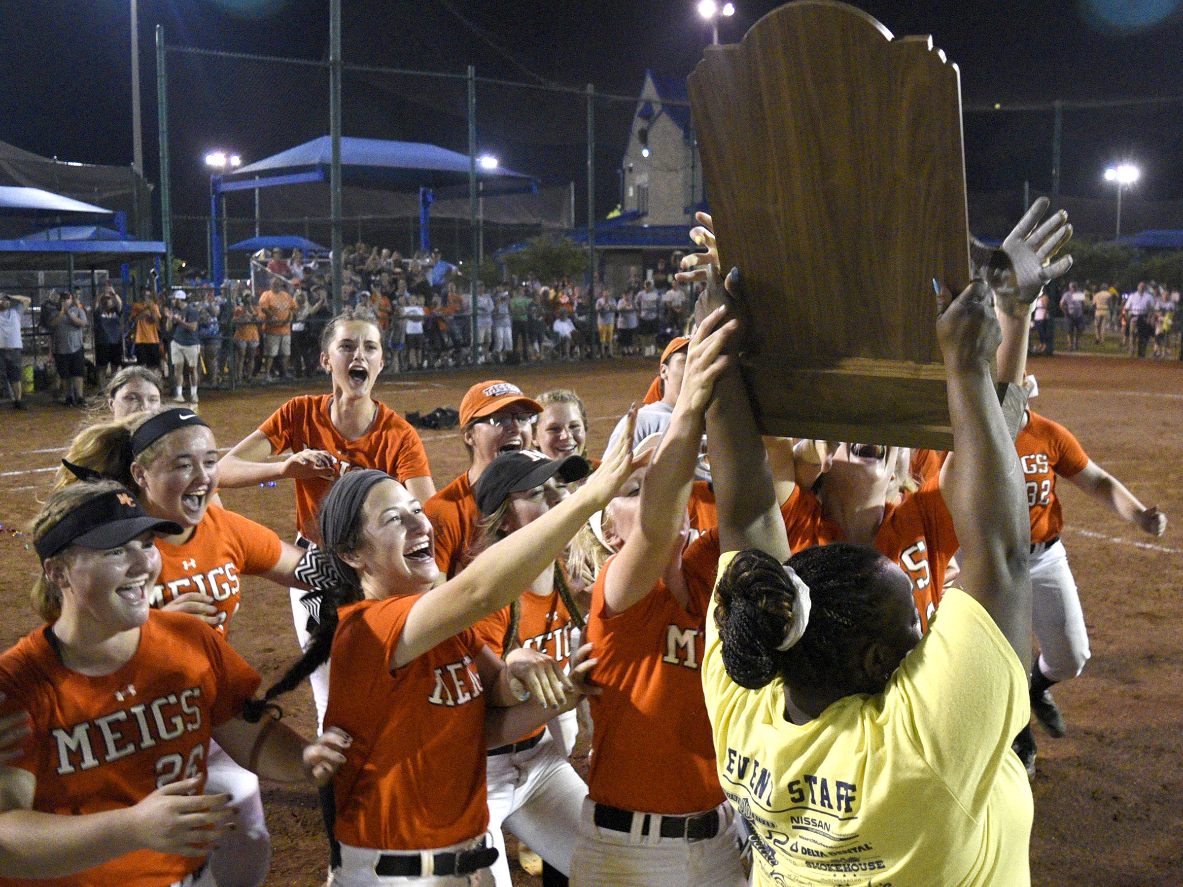 Megis County players rush to claim the championship trophy after defeating White House Heritage 3 to 1 in the final game of the TSSAA Class AA softball championship at the Starplex in Murfreesboro, Tenn. on May 25, 2018.