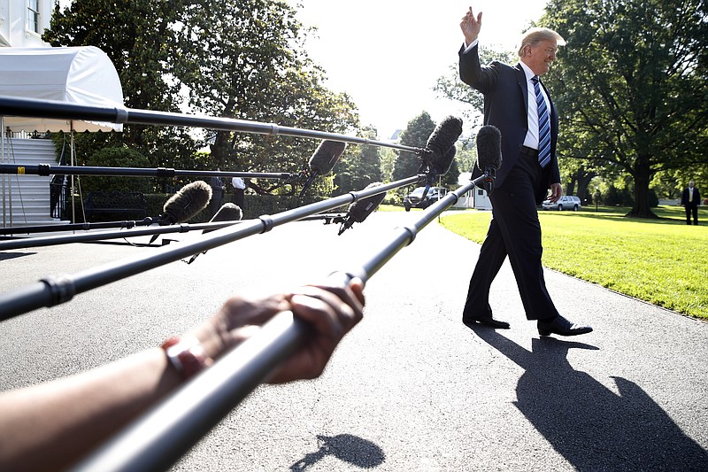 President Donald Trump waves while walking away after speaking to the media, as he walks to the Marine One helicopter Friday, May 25, 2018, on the South Lawn of the White House in Washington.